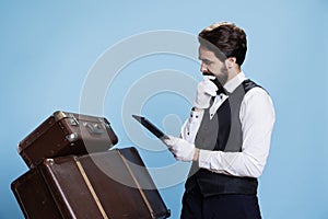 Hotel worker examining reservations photo