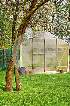 Hothouse with cherry blossom trees in the background