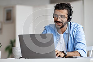 Hotline Operator. Indian Customer Support Manager Man In Headset Working With Laptop