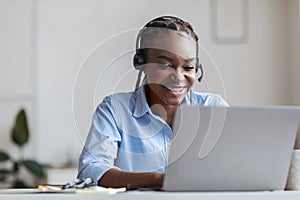 Hotline Support Service. Smiling african woman in headset working in modern office