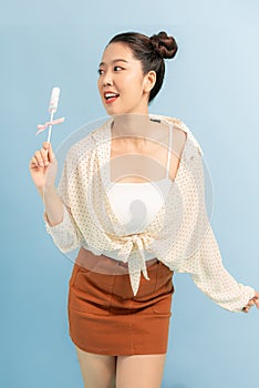 Hoto of pretty funny lady hold lollipop candy hands good mood sweets addicted person wear cropped pullover orange short skirt