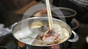 Hotpot japanese shabu while put meat into the soup