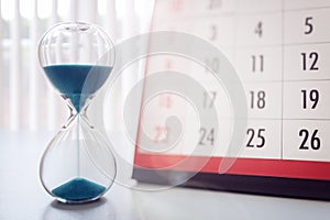 Hour glass and calendar important appointment date, schedule and deadline photo