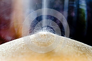 Close-up of sand falling in an hour glass