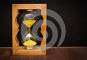 Hourglass as time passing concept for business deadline, urgency and running out of time.