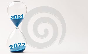 Hourglass with blue sand for change 2021 to 2022 year , Countdown and preparation merry Christmas and happy new year concept