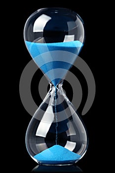 Hourglass with blue sand showing the passage of time