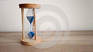 Hourglass. Catch the moment. Sands falling through hourglass. Pass of time and waste time concept.