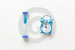 hourglass and clock as time passing concept for business deadline, urgency and running out of time