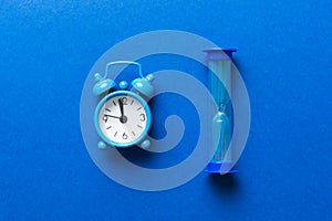 hourglass and clock as time passing concept for business deadline, urgency and running out of time