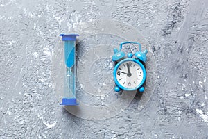 hourglass and clock as time passing concept for business deadline, urgency and running out of time