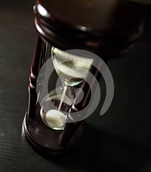 Hourglass in a dark wood photo