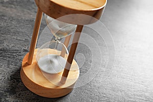 Hourglass with flowing sand on table