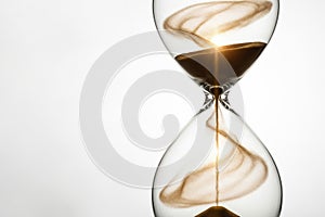 Hourglass with golden light inside. Space for text.