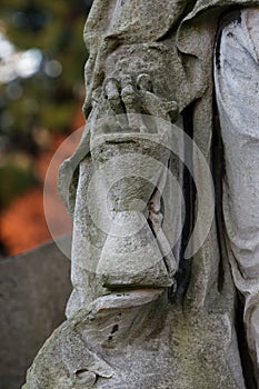 Hourglass in the hand of a grim reaper