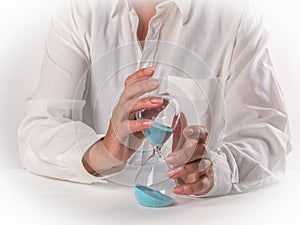 Hourglass in the hands of adult woman