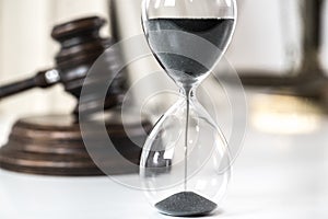 Hourglass.  judge`s gavel. The criminal law.