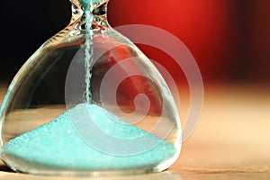 An hourglass measuring the passing time in a countdown to a deadline