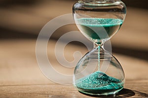 An hourglass measuring the passing time in a countdown to a deadline