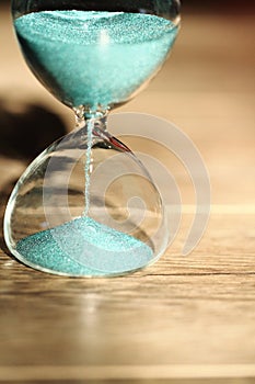 An hourglass measuring the passing time in a countdown to a deadline