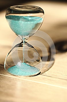 An hourglass measuring the passing time in a countdown to a deadline