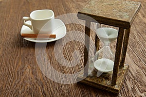 Hourglass on the Oak table as time passing concept for business