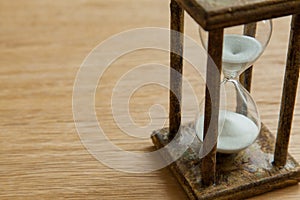Hourglass on the Oak table as time passing concept for business