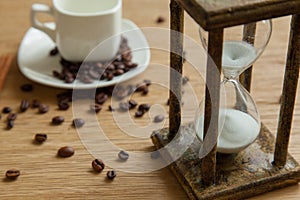 Hourglass on the Oak table as time passing concept for business