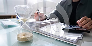 Hourglass In Office. Crunch Time