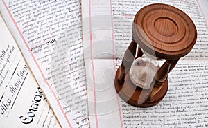 Hourglass on old legal documents