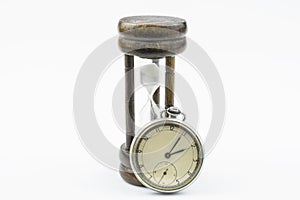 A hourglass and old mechanical watch isolated on a white background