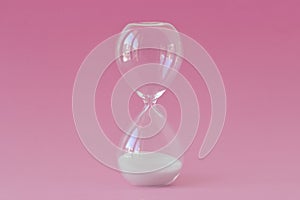 Hourglass on pink background - Concept of infertility and biological clock in women