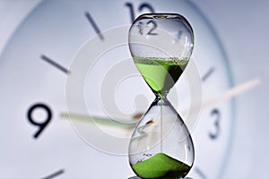 hourglass and round clock measuring time photo