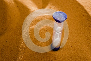 Hourglass on a sand dune beach. concept passage of time