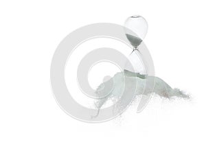 Hourglass and Sand fly in mid air, add more sand of time on gold sand over white background. White hourglass show more time