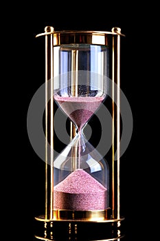 Hourglass sand timer on black photo