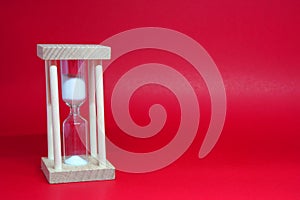 Hourglass or sandglass Isolated Red Background with Copy Space -  Count down , Limit tine competition concept