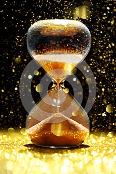 Hourglass showing the passage of time showered in golden light