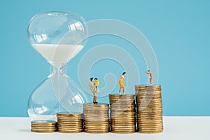 Hourglass and stack coin with savings substantial money inside family