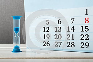 Hourglass stands near the calendar