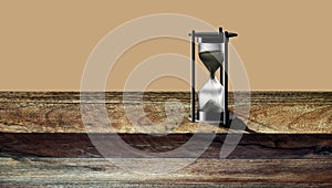 Hourglass Time Hour . An hourglass on a wood background with plenty of room for type.