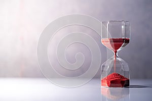 Hourglass on white table, Time passing concept