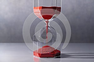 Hourglass on white table, Time passing concept