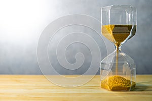 Hourglass on wooden table. Time passing concept
