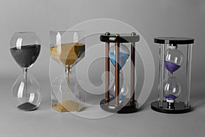 Hourglasses on grey background. Time management concept