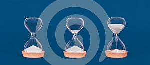 Hourglasses with increasing amount of sand. Concept of time and timely actions, time management and growth mindset