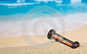 Hourglasses on a sandy beach
