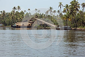 Housboat passing under a bridge