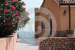 A house above the Mediterranean sea with plants and flowers in the courtyard Pesaro, Italy