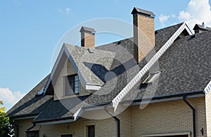 House asphalt shingles rooftop with dormer window, attic skylights, rain gutter, soffits, roof vents